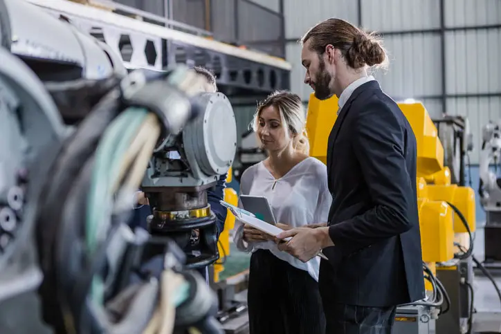 people inspecting manufacturing equipment