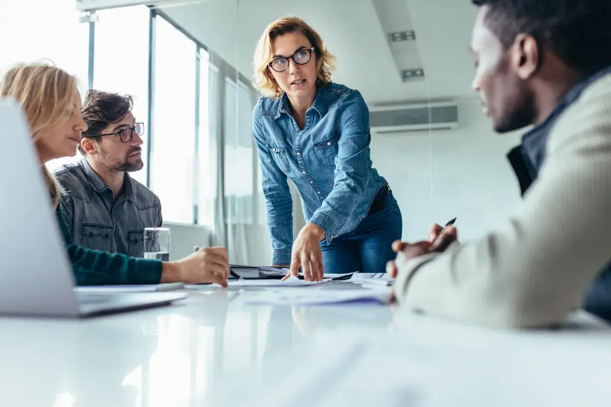 Team collaborating during a meeting with a colleague leading the discussion