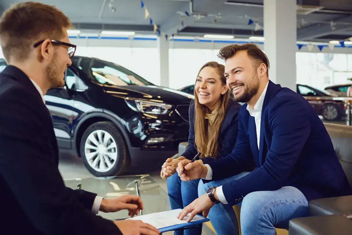 Sales representative reviewing paperwork with a couple