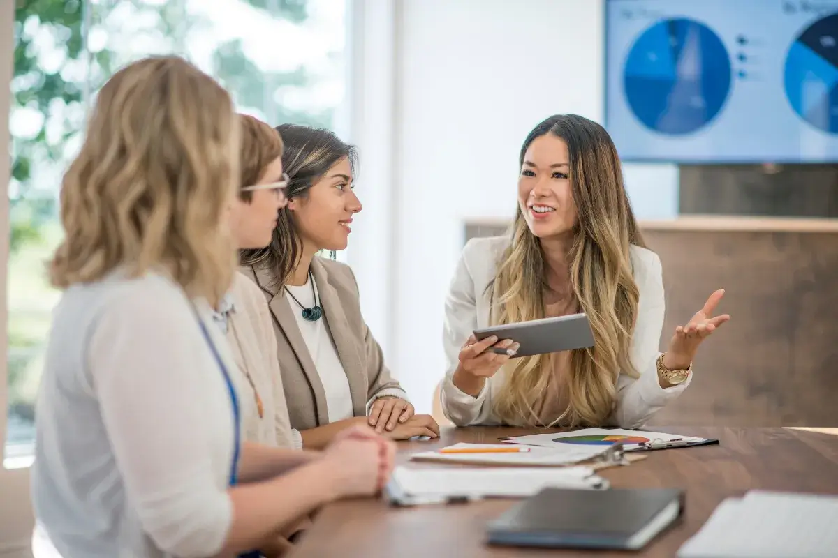 Professional explaining reports and processes to colleagues