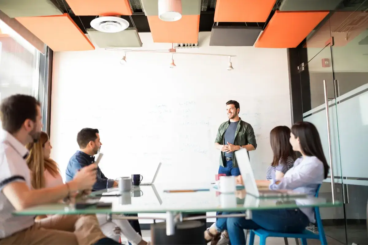 Professional presenting to a team during a meeting