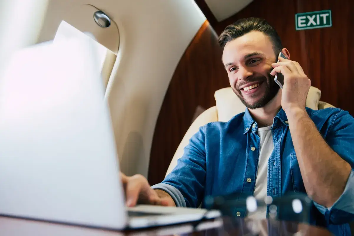 Professional taking a phone call and woking on laptop